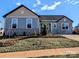 Charming home featuring stone accents, light blue siding, and a well-manicured lawn at 2078 Fordhill St, Rock Hill, SC 29732