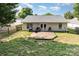 A backyard featuring a wood deck, with chairs and grill outside of the white vinyl-sided house at 228 Grayland Rd, Mooresville, NC 28115