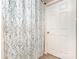 A bathroom featuring an elegantly patterned shower curtain and white door at 228 Grayland Rd, Mooresville, NC 28115