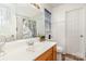 A well-lit bathroom features a large mirror, white shower, and wood-look flooring at 228 Grayland Rd, Mooresville, NC 28115