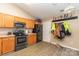 Functional kitchen with wooden cabinets, stainless steel appliances, and vinyl flooring at 228 Grayland Rd, Mooresville, NC 28115