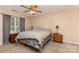 A cozy main bedroom is bright with a ceiling fan, curtains, and neutral walls and carpet at 228 Grayland Rd, Mooresville, NC 28115