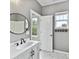 Gray bathroom with a round mirror above a vanity with a white sink at 240 Faust Rd, Davidson, NC 28036