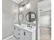 Dual sink bathroom vanity with two round mirrors and modern lighting at 240 Faust Rd, Davidson, NC 28036