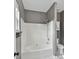 Gray bathroom with shower and tub combo and a white shower stall insert at 240 Faust Rd, Davidson, NC 28036