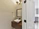 Contemporary half bathroom with floating vanity and stylish fixtures at 240 Faust Rd, Davidson, NC 28036