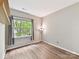 Bedroom with wood floors, a large window and a decorative lamp at 240 Faust Rd, Davidson, NC 28036
