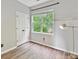 Bedroom with wood floors, a window with green tree views and a double door closet at 240 Faust Rd, Davidson, NC 28036