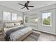 Cozy bedroom with modern decor, hardwood floors, ceiling fan, and three windows at 240 Faust Rd, Davidson, NC 28036