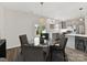Bright dining area adjacent to the kitchen, featuring a glass table and views of the backyard at 240 Faust Rd, Davidson, NC 28036