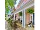 Inviting front porch with white columns, ferns, and meticulous landscaping at 240 Faust Rd, Davidson, NC 28036