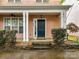 Inviting front porch with white columns, a ceiling fan, and a neatly landscaped entryway at 240 Faust Rd, Davidson, NC 28036