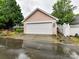 Exterior shot of the garage with an automatic door and white fence offering privacy at 240 Faust Rd, Davidson, NC 28036