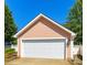 Spacious two-car garage with a clean white door and classic exterior lighting at 240 Faust Rd, Davidson, NC 28036