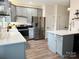 Well-lit kitchen featuring gray cabinets, stainless steel appliances, and a kitchen island at 240 Faust Rd, Davidson, NC 28036