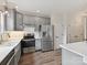 Modern kitchen featuring stainless steel appliances, gray cabinetry, and white countertops at 240 Faust Rd, Davidson, NC 28036