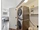 Convenient laundry room with stacked washer and dryer units near kitchen at 240 Faust Rd, Davidson, NC 28036