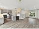 Open concept living room and kitchen area with ample natural light and hardwood floors at 240 Faust Rd, Davidson, NC 28036
