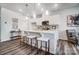 Bright, all-white kitchen features pendant lighting, breakfast bar with seating, and stainless steel appliances at 2415 Hedgecliff Rd, Kannapolis, NC 28025