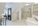 Bright bathroom featuring a walk-in shower, modern vanity, and custom tile at 3009 Brooks Mill Ln, Wingate, NC 28174
