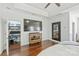 Bright bedroom features hardwood floors, TV, work station, and ensuite bath at 3009 Brooks Mill Ln, Wingate, NC 28174