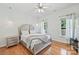 Bright bedroom with hardwood floors, neutral paint, and natural light from the windows at 3009 Brooks Mill Ln, Wingate, NC 28174