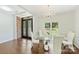 Bright and spacious dining room featuring a modern chandelier, a glass dining table and large windows at 3009 Brooks Mill Ln, Wingate, NC 28174
