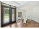 Elegant foyer with a decorative wrought iron door that opens to a formal dining room at 3009 Brooks Mill Ln, Wingate, NC 28174