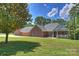 Charming single-story brick home featuring a well-manicured lawn and a welcoming front porch with a white railing at 3009 Brooks Mill Ln, Wingate, NC 28174