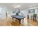 Large game room with a pool table, hardwood floors, and decorative lighting fixture at 3009 Brooks Mill Ln, Wingate, NC 28174