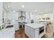 Bright, open kitchen featuring white cabinetry, a marble countertop island, and stainless steel appliances at 3009 Brooks Mill Ln, Wingate, NC 28174