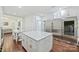Spacious kitchen featuring a large marble countertop island, stainless steel appliances, and custom white cabinets at 3009 Brooks Mill Ln, Wingate, NC 28174