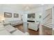 Open-concept living room featuring a fireplace, hardwood floors, modern chandelier, and stylish grey leather furniture at 3009 Brooks Mill Ln, Wingate, NC 28174