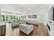 Bright, open living room with hardwood floors, modern leather sofas and oversized picture windows with view to the outdoors at 3009 Brooks Mill Ln, Wingate, NC 28174