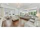 Bright living room with hardwood floors, modern leather sofas, view to kitchen and backyard at 3009 Brooks Mill Ln, Wingate, NC 28174
