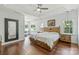 Spacious main bedroom with hardwood floors, tray ceiling, ceiling fan and backyard view at 3009 Brooks Mill Ln, Wingate, NC 28174