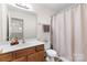 Well-lit bathroom with a single vanity, a toilet, updated faucets, and a shower/tub combination with a neutral curtain at 3030 Priory Ridge Dr, Fort Mill, SC 29707