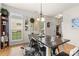 Dining room with a rustic table, hardwood floors, and ample natural light, perfect for gatherings at 3030 Priory Ridge Dr, Fort Mill, SC 29707