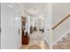 Welcoming foyer with tile flooring, staircase, coat storage, and a view into the open living area at 3030 Priory Ridge Dr, Fort Mill, SC 29707