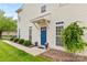 Inviting front entrance featuring a bright blue door, lovely landscaping, and a welcoming exterior at 3030 Priory Ridge Dr, Fort Mill, SC 29707