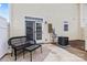 A cozy patio with a black wicker seating set including a table and bench located off the rear of the home at 3030 Priory Ridge Dr, Fort Mill, SC 29707
