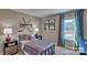 Themed bedroom featuring hockey-related decor, window with curtains, and a comfortable bed and side tables at 3068 Ora Smith Rd, Lincolnton, NC 28092