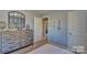 Stylishly decorated bedroom showcasing a dresser with a decorative mirror and unique wall decor at 3068 Ora Smith Rd, Lincolnton, NC 28092