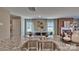 Bright kitchen island with sink and granite countertop overlooking the dining area with fireplace at 3068 Ora Smith Rd, Lincolnton, NC 28092