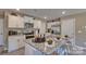 Bright kitchen featuring granite countertops, stainless steel appliances, and a convenient island with seating at 3068 Ora Smith Rd, Lincolnton, NC 28092