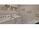 Bright laundry room features a modern washer, dryer, and convenient shelving for storage at 3068 Ora Smith Rd, Lincolnton, NC 28092