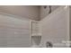 Tiled shower showcasing a built-in shelf, offering convenience and a clean aesthetic for a comfortable showering experience at 3068 Ora Smith Rd, Lincolnton, NC 28092