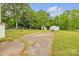 View of the backyard featuring a detached garage and a storage shed at 3101 Hickory Hwy, Statesville, NC 28677