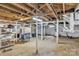 Spacious unfinished basement with exposed beams and multiple support columns at 3101 Hickory Hwy, Statesville, NC 28677