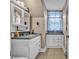 Compact bathroom featuring built-in storage, tile flooring and ample natural light at 3101 Hickory Hwy, Statesville, NC 28677